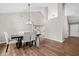 Spacious dining room with hardwood floors, vaulted ceilings, and a modern chandelier above the large dining table at 455 Ellesmere Way, Buford, GA 30518
