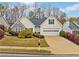 Inviting one-story home with a well-maintained lawn and blooming bushes at 455 Ellesmere Way, Buford, GA 30518