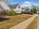 Street view of a well-kept one-story home with manicured landscaping and a sidewalk at 455 Ellesmere Way, Buford, GA 30518