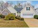 Charming one-story home with manicured landscaping and a two-car garage at 455 Ellesmere Way, Buford, GA 30518