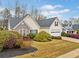 Well-kept one-story home featuring stone accents and lush, manicured bushes at 455 Ellesmere Way, Buford, GA 30518