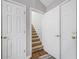 Hallway features hardwood flooring with carpeted stairs at 455 Ellesmere Way, Buford, GA 30518