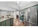 Modern kitchen boasts stainless steel appliances, ample counter space, and plenty of natural light from the breakfast nook at 455 Ellesmere Way, Buford, GA 30518