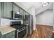Well-equipped kitchen with stainless steel appliances, ample counter space, and hardwood floors for a sleek modern look at 455 Ellesmere Way, Buford, GA 30518