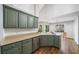 Inviting kitchen with an island, stainless steel appliances, hardwood floors and large windows for natural light at 455 Ellesmere Way, Buford, GA 30518
