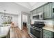 Bright kitchen with stainless appliances, a large window, and hardwood flooring, perfect for culinary enthusiasts at 455 Ellesmere Way, Buford, GA 30518
