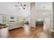 Open concept living room with kitchen access and hardwood floors at 455 Ellesmere Way, Buford, GA 30518