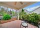 Relaxing covered patio with brick flooring and a view of the well-maintained backyard at 455 Ellesmere Way, Buford, GA 30518