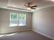 Neutral bedroom with a ceiling fan, recessed lighting and a large picture window for plenty of natural light at 871 Pineberry Ct, Grayson, GA 30017