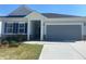 Charming single-Gathering home featuring stone accents, a two-car garage, and well-maintained lawn at 871 Pineberry Ct, Grayson, GA 30017
