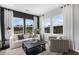 Bright living room boasts large windows, contemporary furnishings, and neutral tones for a cozy atmosphere at 871 Pineberry Ct, Grayson, GA 30017