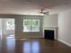 Bright living room featuring a fireplace, ceiling fan, and hardwood flooring throughout at 871 Pineberry Ct, Grayson, GA 30017