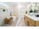 Luxurious bathroom featuring a soaking tub, dual vanities, and modern fixtures at 1288 Gate Post Ln, Powder Springs, GA 30127