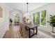 Elegant dining room featuring large windows, a modern light fixture, and comfortable seating at 1288 Gate Post Ln, Powder Springs, GA 30127