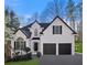 Charming two-story home featuring a manicured lawn, black shutters, and a two-car garage at 1288 Gate Post Ln, Powder Springs, GA 30127