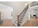 Bright foyer with hardwood floors, stairway with metal spindles, and entry to open living areas at 1288 Gate Post Ln, Powder Springs, GA 30127