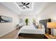 Bright main bedroom with a tray ceiling, a fan, an outdoor view, and modern decor at 1288 Gate Post Ln, Powder Springs, GA 30127
