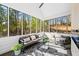 Bright sunroom with floor to ceiling windows, gray furnishings, and a ceiling fan at 1288 Gate Post Ln, Powder Springs, GA 30127