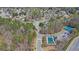 Aerial view of a community featuring a pool, tennis court, and lush green spaces, offering a vibrant and active lifestyle at 1621 Telfair Chase Way, Lawrenceville, GA 30043