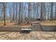 Large backyard with a stone patio, retaining wall, and playground, perfect for entertaining and enjoying the outdoors at 1621 Telfair Chase Way, Lawrenceville, GA 30043