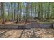 Serene backyard featuring a stone patio, retaining wall, and playground, perfect for relaxation and outdoor enjoyment at 1621 Telfair Chase Way, Lawrenceville, GA 30043