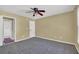 Bedroom with neutral walls, carpet, ceiling fan and ensuite bathroom with a shower/tub combination at 1621 Telfair Chase Way, Lawrenceville, GA 30043