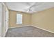 Neutral bedroom features carpeted floors, a ceiling fan, and a window at 1621 Telfair Chase Way, Lawrenceville, GA 30043