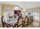 Elegant dining room with a large table, chandelier, and decorative window treatments at 1621 Telfair Chase Way, Lawrenceville, GA 30043