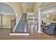 Grand foyer featuring hardwood floors, staircase with decorative iron railing, and abundant natural light at 1621 Telfair Chase Way, Lawrenceville, GA 30043