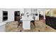 Open kitchen with white cabinetry, island with seating, and stainless steel appliances at 1621 Telfair Chase Way, Lawrenceville, GA 30043