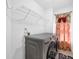 Convenient laundry room with modern washer and dryer, and overhead storage shelves at 1621 Telfair Chase Way, Lawrenceville, GA 30043