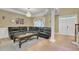 Comfortable living room showcases a plush leather sectional and decorative chandelier at 1621 Telfair Chase Way, Lawrenceville, GA 30043