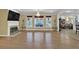Spacious living room with hardwood floors, fireplace, and an abundance of natural light from large windows at 1621 Telfair Chase Way, Lawrenceville, GA 30043