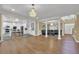 Spacious living room featuring gleaming hardwood floors, stylish chandelier, and elegant columns at 1621 Telfair Chase Way, Lawrenceville, GA 30043