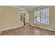 Cozy living room with hardwood floors, neutral paint, and an elegant archway leading to the foyer at 1621 Telfair Chase Way, Lawrenceville, GA 30043