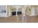 Open-concept living space with hardwood floors, elegant columns, and access to the kitchen at 1621 Telfair Chase Way, Lawrenceville, GA 30043