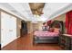 Spacious bedroom with hardwood floors, tray ceiling and adjacent sitting area at 1621 Telfair Chase Way, Lawrenceville, GA 30043