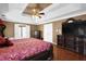 Well-lit main bedroom featuring hardwood floors, a tray ceiling, and generous space at 1621 Telfair Chase Way, Lawrenceville, GA 30043