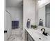 Bathroom with gray vanity, white walls, and combination shower and tub at 245 Raleigh Way, Villa Rica, GA 30180