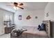 Bedroom with sports themed decor, ceiling fan, bedside table, and a window at 245 Raleigh Way, Villa Rica, GA 30180