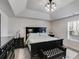 Bedroom with tray ceilings, dark furniture, plush carpeting, and a large window at 245 Raleigh Way, Villa Rica, GA 30180