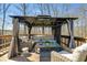 Outdoor deck area includes wicker furniture, lighting, and shielding curtains at 245 Raleigh Way, Villa Rica, GA 30180