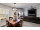Open concept dining room with modern chandelier and natural light at 245 Raleigh Way, Villa Rica, GA 30180