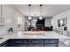 Open concept kitchen featuring quartz counters, black cabinets, and stainless appliances at 245 Raleigh Way, Villa Rica, GA 30180