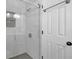 A modern shower boasts marble-tiled walls and a sleek glass enclosure, creating a luxurious showering experience at 345 Ivy Mill Ct, Roswell, GA 30076