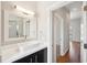 White bathroom with vanity, mirror and hardwood floors outside the door at 472 Martin Se St # 1, Atlanta, GA 30312