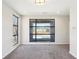An airy bedroom boasts modern black-trimmed windows and plush grey carpeting for a cozy feel at 472 Martin Se St # 1, Atlanta, GA 30312