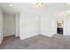 An en-suite carpeted bedroom features bright, neutral walls and an adjoining bathroom at 472 Martin Se St # 1, Atlanta, GA 30312