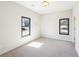 Bright bedroom with neutral carpet and two windows at 472 Martin Se St # 1, Atlanta, GA 30312