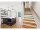 A modern staircase with hardwood steps and white risers leads to the upper level at 472 Martin Se St # 1, Atlanta, GA 30312